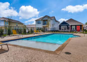 Thumbnail 5 of 20 - a swimming pool with houses in the background