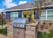 Thumbnail 6 of 20 - a stainless steel barbecue grill in front of a house