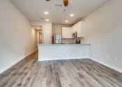 Thumbnail 8 of 20 - the living room and kitchen of a new home with wood flooring