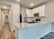 Thumbnail 11 of 20 - a kitchen with a counter top and a stainless steel refrigerator