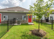 Thumbnail 17 of 20 - the front of a house with a yard and a tree