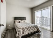 Thumbnail 5 of 14 - a bedroom with a large window and a bed