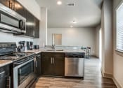 Thumbnail 8 of 14 - a kitchen with stainless steel appliances and a counter top