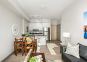 Thumbnail 3 of 15 - A modern kitchen with a dining table and a couch.