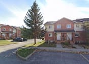 Thumbnail 1 of 14 - the front yard of a brick house with a sidewalk and a tree
