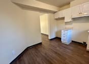 Thumbnail 6 of 14 - an empty living room with a hard wood floor