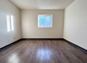 Thumbnail 10 of 14 - an empty room with wooden floors and a window