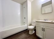 Thumbnail 12 of 14 - a bathroom with a toilet and a sink and a bath tub