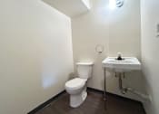 Thumbnail 13 of 14 - a small bathroom with a toilet and a sink