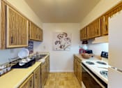 Thumbnail 2 of 15 - A  kitchen with a refrigerator