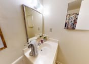 Thumbnail 14 of 15 - A small white sink with a grey towel on it.