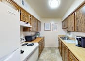 Thumbnail 8 of 19 - a kitchen with wooden cabinets and a refrigerator