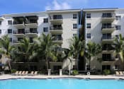 Thumbnail 4 of 24 - a large swimming pool in front of an apartment building