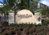 Thumbnail 24 of 24 - a sign for compass place apartments in front of palm trees