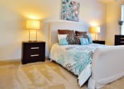 Thumbnail 16 of 24 - a bedroom with a bed and two nightstands and a window