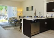 Thumbnail 9 of 24 - a kitchen with stainless steel appliances and a granite counter top