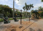 Thumbnail 19 of 24 - a playground with a swing set and a jungle gym