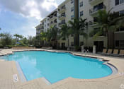 Thumbnail 5 of 24 - a large swimming pool in front of an apartment building