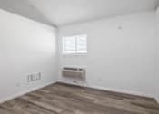 Thumbnail 4 of 22 - A room with a window and a wall-mounted air conditioner.