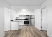 Thumbnail 22 of 22 - A kitchen with white cabinets and stainless steel appliances.