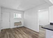 Thumbnail 18 of 22 - A room with a white door, a window with blinds, and a radiator on the wall.