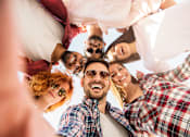 Thumbnail 10 of 22 - a group of people standing in a circle with their heads together