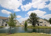 Thumbnail 141 of 147 - This is a picture of a fountain in a pond with building exteriors at Nantucket Apartments, in Loveland, OH.