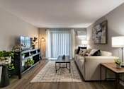 Thumbnail 39 of 65 - A modern living room with a large sofa, a coffee table, and a TV in a 1 bedroom, 1 bath 560 square foot apartment at Aspen Village Apartments in the Westwood neighborhood of Cincinnati, OH.