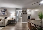 Thumbnail 37 of 65 - A modern living room with a white couch, a coffee table, and a painting on the wall in a 1 bedroom, 1 bath 560 square foot apartment at Aspen Village Apartments in the Westwood neighborhood of Cincinnati, OH.