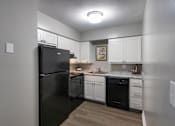 Thumbnail 4 of 65 - A black refrigerator is in a kitchen with white cabinets in a 1 bedroom, 1 bath 560 square foot apartment at Aspen Village Apartments in the Westwood neighborhood of Cincinnati, OH.