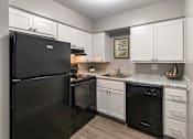 Thumbnail 34 of 65 - A black refrigerator is in a kitchen with white cabinets in a 1 bedroom, 1 bath 560 square foot apartment at Aspen Village Apartments in the Westwood neighborhood of Cincinnati, OH.