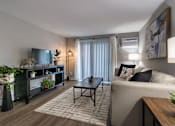 Thumbnail 41 of 65 - A living room with a couch, coffee table, and plantsin a 1 bedroom, 1 bath 560 square foot apartment at Aspen Village Apartments in the Westwood neighborhood of Cincinnati, OH.