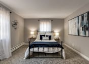 Thumbnail 43 of 65 - A bedroom with a bed, two lamps, and a painting on the wall in a 1 bedroom, 1 bath 560 square foot apartment at Aspen Village Apartments in the Westwood neighborhood of Cincinnati, OH.