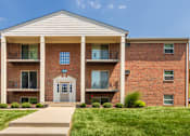 Thumbnail 61 of 65 - Brick apartment building with secure entry, balconies, and sidewalk at Aspen Village