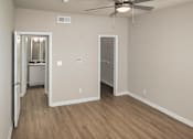 Thumbnail 9 of 61 - Bedroom with wood-look flooring, ceiling fan in a one-bedroom apartment with 1-car garage