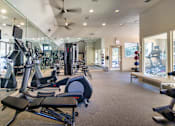 Thumbnail 35 of 52 - The 24-hour fitness center with treadmills, elliptical machines, and free weights at The Brownstones Townhome Apartments in the Far North Dallas neighborhood of Dallas, TX..