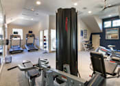 Thumbnail 39 of 52 - The 24-hour fitness center with treadmills, elliptical machines, and free weights at The Brownstones Townhome Apartments in the Far North Dallas neighborhood of Dallas, TX..