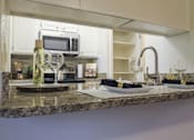 Thumbnail 3 of 42 - This is a photo of the kitchen of a 1245 square foot 2 bedroom apartment at Cambridge Court Apartments.