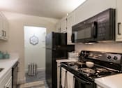 Thumbnail 7 of 42 - This is a photo of the kitchen in a 692 square foot 1 bed, 1 bath model aprtment at Cambridge Court Apartments in Dallas Texas