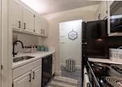 Thumbnail 1 of 42 - This is a photo of the kitchen in a 692 square foot 1 bed, 1 bath model aprtment at Cambridge Court Apartments in Dallas Texas