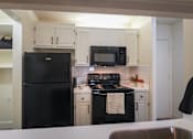 Thumbnail 2 of 42 - Photo of the kitchen in a 692 square foot 1 bed, 1 bath model aprtment at Cambridge Court Apartments in Dallas Texas