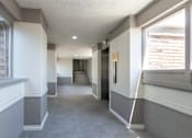 Thumbnail 36 of 42 - This is a photo of an elevatorin an open air hallway with new tile in the 450 square foot efficiency apartment at Cambridge Court Apartments in Dallas, TX.