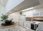 Thumbnail 3 of 40 - This is a photo of the kitchen of the 575 square foot 1 bedroom, 1 bath apartment at Canyon Creek Apartments in Dallas, TX