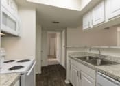 Thumbnail 6 of 40 - This is a photo of the kitchen in the 880 square foot 2 bedroom, 2 bath apartment at Canyon Creek Apartments in Dallas, TX