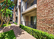 Thumbnail 40 of 40 - Apartment building exterior at Canyon Creek Apartments in the Dallas Midtown neighborhood of Dallas, TX.