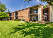 Thumbnail 37 of 40 - Apartment building exterior at Canyon Creek Apartments in the Midtown neighborhood of Dallas, TX.