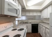 Thumbnail 7 of 40 - This is a photo of the kitchen in a 717 square foot 1 bedroom, 1 bath apartment at Canyon Creek Apartments in Dallas, TX