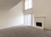 Thumbnail 9 of 40 - This is a photo of the living room with fireplace in a 717 square foot 1 bedroom, 1 bath apartment at Canyon Creek Apartments in Dallas, TX