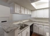 Thumbnail 8 of 40 - This is a photo of the kitchen  breakfast bar in a 717 square foot 1 bedroom, 1 bath apartment at Canyon Creek Apartments in Dallas, TX