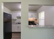 Thumbnail 8 of 41 - Kitchen and breakfast bar view inside a two-bedroom, two-bath apartment at Compton Lake Apartments